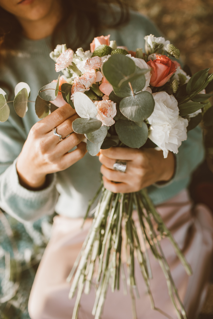 Person Holding Bouquet of Flowers